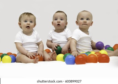 Baby Triplets Engaged And Playing With Colorful Balls