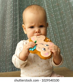 The Baby Is Trying New Food, A Gingerbread In The Form Of A Mouse And He Does Not Like