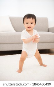 Baby Trying Stand Up In The Living Room