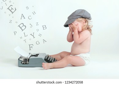 baby typing with a old typewriter on white background