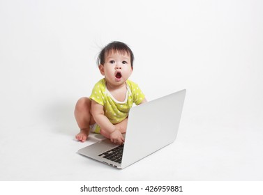 Baby typing on modern laptop isolated on white background, asian baby playing with laptop.