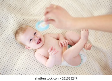 Baby Watching Mother Holding A Soother