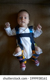 A Baby Wearing A Harness That Corrects Hip Dysplasia