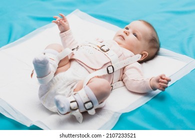 A Baby Wearing A Harness That Corrects Hip Dysplasia