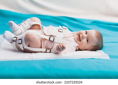 A Baby Wearing A Harness That Corrects Hip Dysplasia