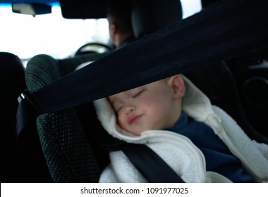 Baby In White Pluffy Jackget Sit Sleeping In Rear-facing  Car Seat 