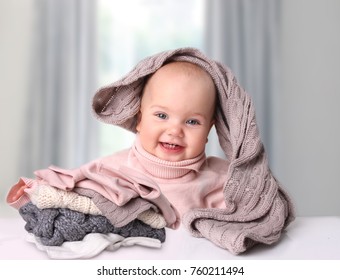 Baby In Winter Warming Up Clothing.Child With Stack Knitted Clothes.