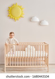 Baby In The Wooden Cradle And Crib Style, Modern Room And Toy In The Pink Wall.