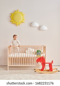 Baby In The Wooden Cradle And Crib Style, Modern Room And Toy In The Pink Wall.