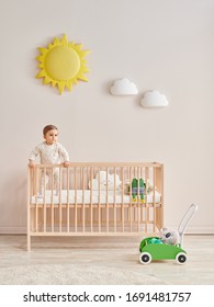 Baby In The Wooden Cradle And Crib Style, Modern Room And Toy In The Pink Wall.