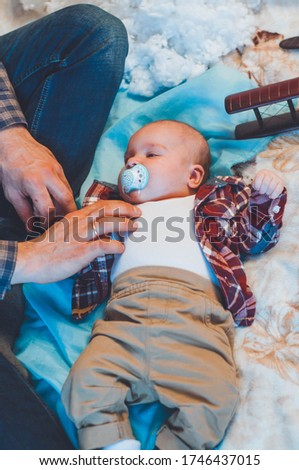 baby with a wooden plane