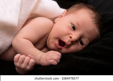 Baby Yawning On Black Background