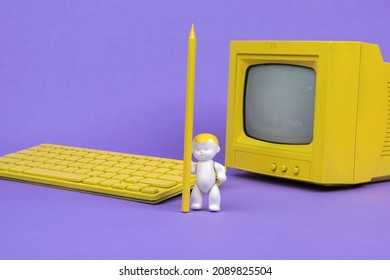 A Baby With A Yellow Pencil Near A Yellow Monitor And Computer On A Purple Background. The Concept Of Online Education.