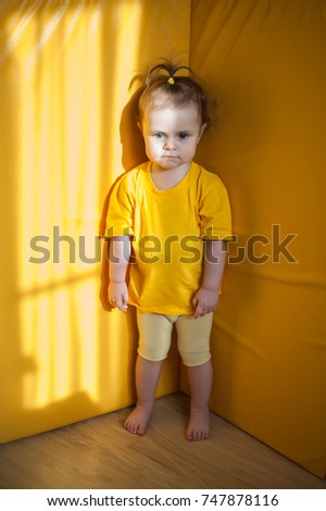 baby-yellow-tshirt-standing-corner-450w-