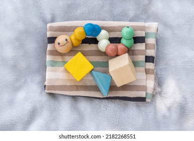 Baby,infant Clothes,wooden Train Wagon,cute Multi Colored Caterpillar,cubes Toys On Soft Grey Blanket.new Born Infant Clothing And Ecological Toys,donation Or Baby Shower.gift Box.it's A Boy