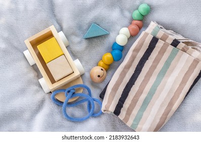 Baby,infant Clothes,wooden Train Wagon,cute Multi Colored Caterpillar,cubes Toys On Soft Grey Blanket.new Born Infant Clothing And Ecological Toys,donation Or Baby Shower.gift Box.it's A Boy