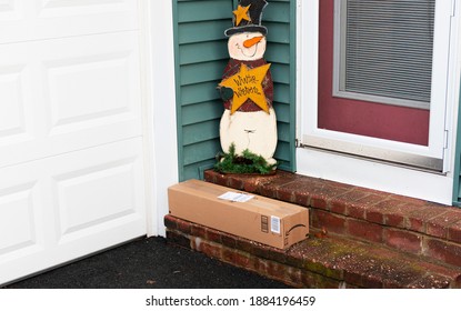 Babylon, New York, USA - 22 December 2020: A Package Is Left By The Side Door O A Residential House In December Vulnerable To Porch Pirate Thieves.