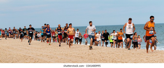 Babylon, New York, USA - 24 June 2019: Hundreds of runners are running a one mile race on the beach as part of the New York State Parks Summer Series of races.
