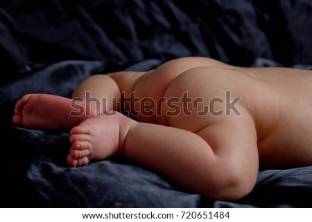 Similar – Baby yawning lying on a carpet