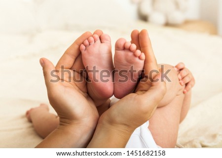Baby's feet in mother hands. Mom and her Child. Happy Family concept. Beautiful conceptual image of Maternity