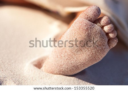 Baby's feet on the beach in  the Caribbean part of Mexico, Riviera Maya. Summer beach background.