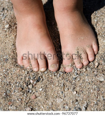 Babys feet in the sand