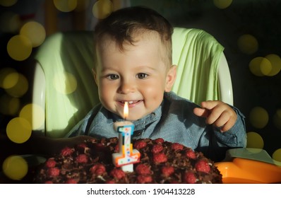 Baby's First Birthday. Little Boy's Birthday, Cake With A Candle. The Child Rejoices, Smiles. Smiling Child