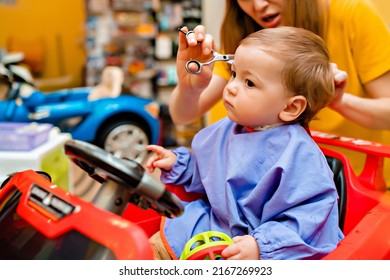 Baby's first haircut. Cute little boy at the professional children's hairdresser. High quality photo