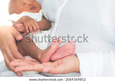 Baby's foot of African black skin newborn, Placed on the mother's hand, concept to showing love and concern for her children, And is love family relationship.