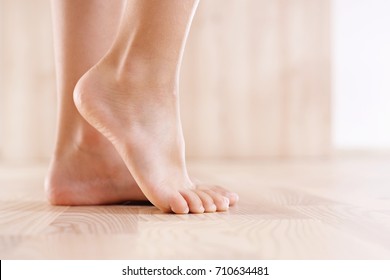 Baby's foot.  Feet of baby's naked against the background of the wooden floor 