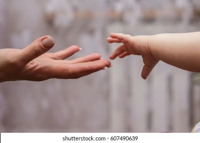 Baby's Hand Reaching Up To Its