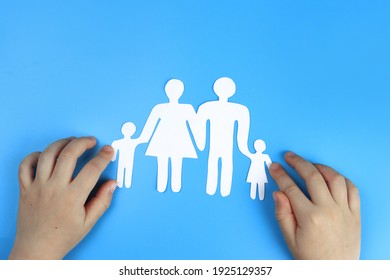 Baby's hands support Paper family - Shutterstock ID 1925129357