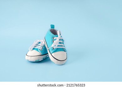 Baby's little blue sneakers on a colorful background. The concept of waiting for a baby and the concept of traveling with baby, children's lifestyle. Copy space, flat lay - Powered by Shutterstock