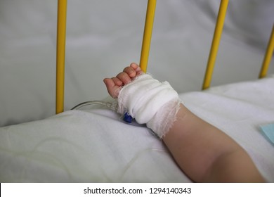 Baby's Little Hand With A Catheter In A Hospital / Post Surgery Recovery Or Illness Treatment. Coronavirus / Covid-19 Pandemic. 