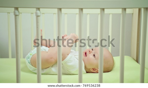 Babys Lying On Green Linen Crib Stock Photo Edit Now 769536238