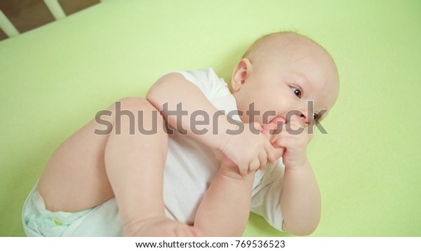 Babys Lying On Green Linen Crib Stock Photo Edit Now 769536523