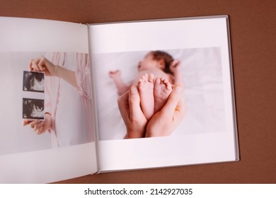 Baby's Photo Book On Brown Background . Children's Emotional Portrait.Cute Toddler Boy