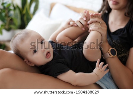 baby's tiny feet in paren't hands. parent holding newborn in arms. happy family
