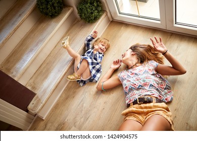 Babysitter With Child Having Fun On The Stairs 
