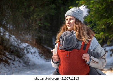 Babywearing Young Mother With Her Baby Winter Outdoor Adventure With Copy Space.