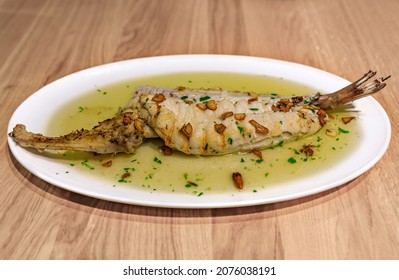 Bacalao With Pil Pil Sauce, Traditional Basque Dish With Salt Cod In Garlic-infused Oil With Dried Guindilla Chili, In A Restaurant In Pamplona, Spain