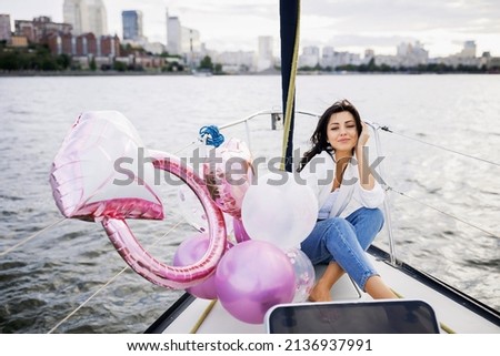 Bachelorette party on a yacht, a beautiful girl on a walk along the river. setting sun
