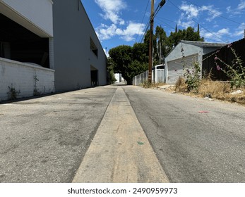 back alley behind a factory building with sheds and houses - low angle shot - Powered by Shutterstock
