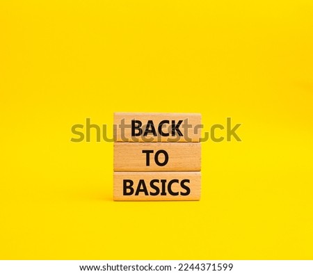 Back to basics symbol. Concept word Back to basics on wooden blocks. Beautiful yellow background. Business and Back to basics concept. Copy space