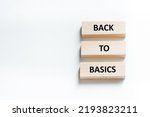 back to basics text on wooden blocks that lie on a white background