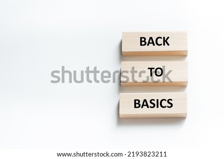 back to basics text on wooden blocks that lie on a white background