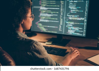 Back behind view photo of dark skin programmer lady look big monitor check id-address work overtime check debugging system wear specs casual shirt sit table late night office indoors - Shutterstock ID 1687431796