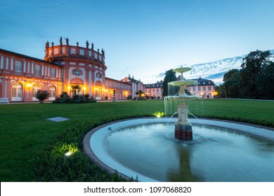 Back of Biebrich Castle in the German city of Wiesbaden with water fountain at dusk - Shutterstock ID 1097068820