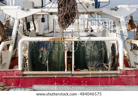 back of a big fishingboat in the harbour ready to go out to the ocean