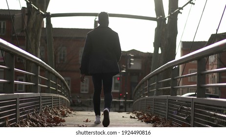 Back Of Black African Man Walking Outside In Urban City